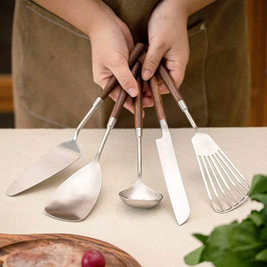 Holding 5 Luxury Chef Style Kitchen Utensils For Serving