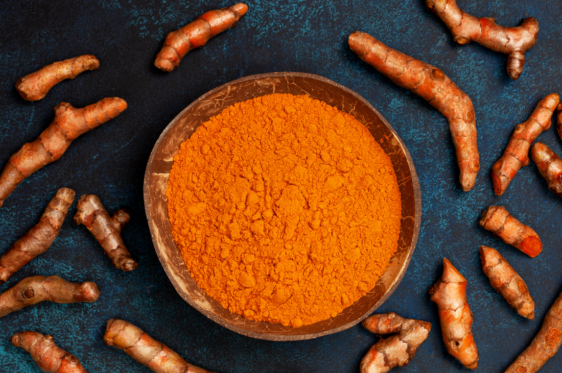 Turmeric Root With Wooden Bowl Of Raw Turmeric Powder