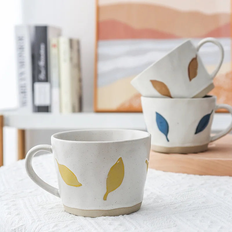 Craft Style Pottery Ceramic Mugs With Colorful Leaves In Yellow Blue And Brown Leaf Colors