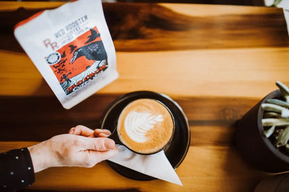 Enjoying A Latte Made With Red Rooster Old Crow Cuppa Joe Coffee