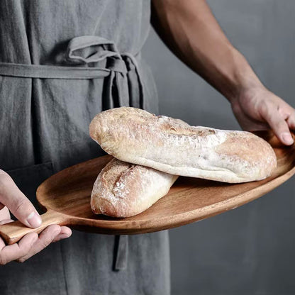 Holding Farmhouse Style Organic Bread Loaves On Acacia Wooden Leaf Serving Tray