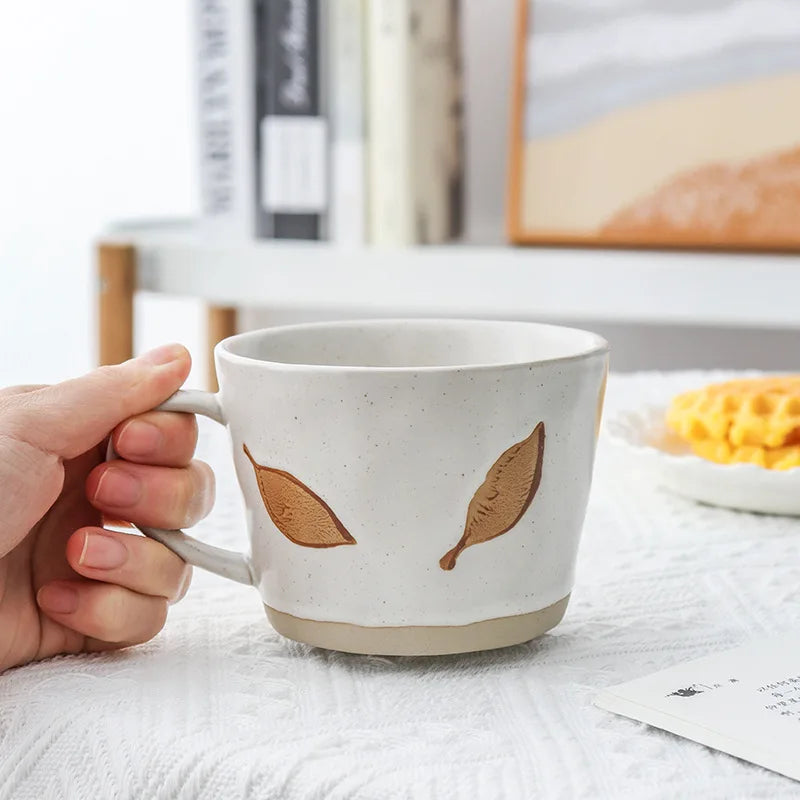 Holding A Craft Style Ceramic Mug With Leaf Pattern In Brown Leafy Tones For Fall Favorite Drinks