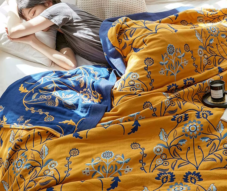 Woman Sleeping In Bed With Cotton Quilt Regal Floral Pattern Reversible Coverlet In Blue And Yellow Colors