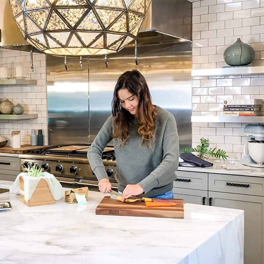 Woman In Kitchen Cutting Fresh Vegetables Using Compost Bags If You Care Compostable Food Waste Bags
